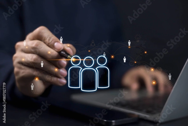 Fototapeta Businessman using digital technology for human resource management, recruitment, and team connection. Concept of networking, employee data, and HR innovation in modern business.