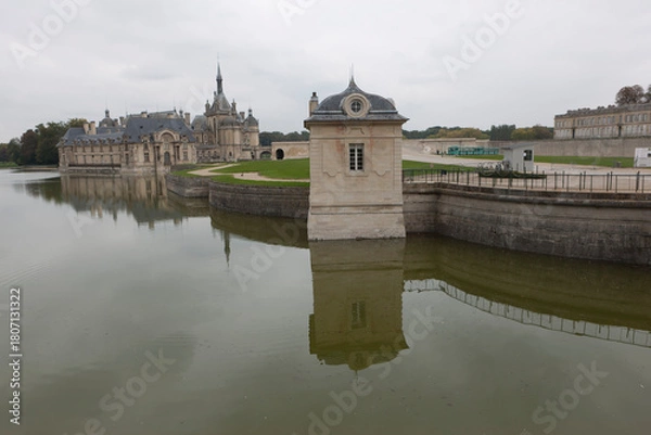 Fototapeta France's Chantilly Castle on a cloudy summer day