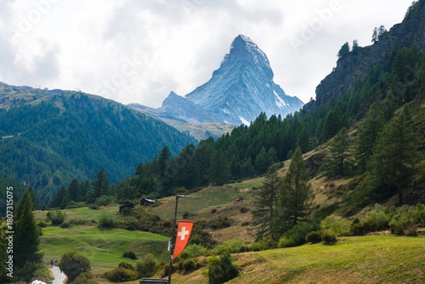 Obraz Matterhorn in green Swiss valley with a Gornera River flowing from the mountain with Swiss flag in Zermatt, Switzerland
