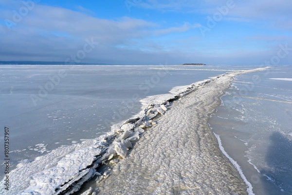 Fototapeta Vast Frozen Lake with a Pressure Ridge Under a Blue Sky
