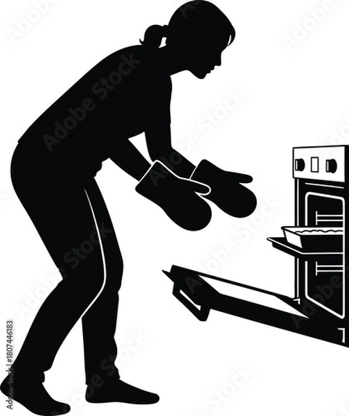 Fototapeta Silhouette of Woman Baking and Taking Food Out of Oven