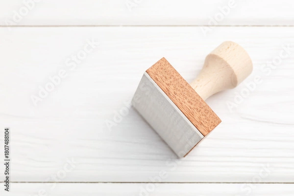 Fototapeta One wooden stamp on white table, top view. Space for text
