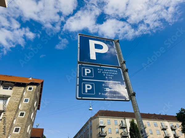 Fototapeta Copenhagen, Denmark - September 8, 2025: A sign showing rules for parking and charging for electric vehicles in Norrebro district