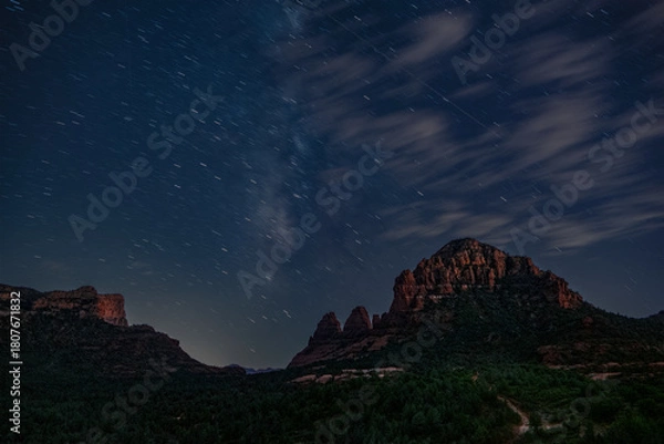 Fototapeta Sedona nightscape features the Milky Way and clouds over this iconic landscape