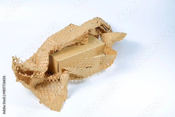 Fototapeta Parcel wrapped in eco-friendly wrapping paper, lightweight bubble wrap for protective packaging, Environmentally friendly Honeycomb paper hexagonal shape made of cardboard recycled craft paper.