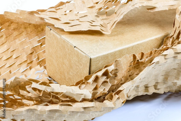 Fototapeta Parcel wrapped in eco-friendly wrapping paper, lightweight bubble wrap for protective packaging, Environmentally friendly Honeycomb paper hexagonal shape made of cardboard recycled craft paper.