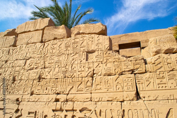 Fototapeta Ancient Egyptian hieroglyphs on stone wall, Karnak Temple Complex, Luxor, Egypt, Africa. Stone carvings with hieroglyphs at Karnak temple, Luxor, Thebe
