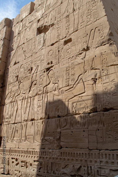 Fototapeta Ancient Egyptian hieroglyphs on stone wall, Karnak Temple Complex, Luxor, Egypt, Africa. Stone carvings with hieroglyphs at Karnak temple, Luxor, Thebe