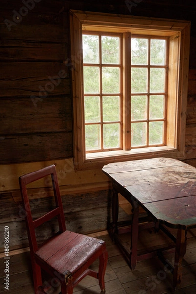 Fototapeta  "Aged Log Cabin Interior with Chair and Table by Window at Sigdal Skanzen, Prestfoss, Norway"