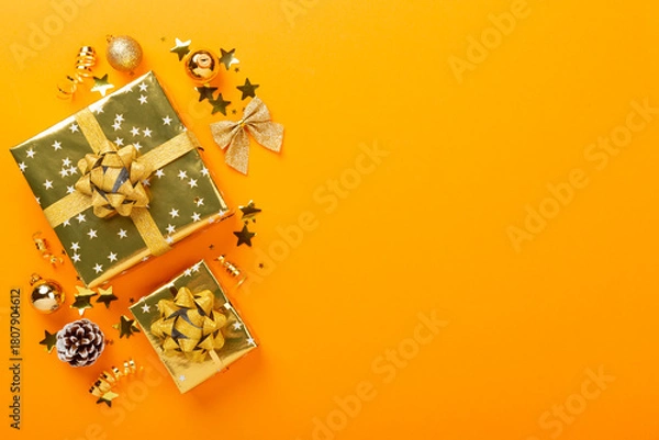 Obraz Golden gift boxes and decor on color background, top view
