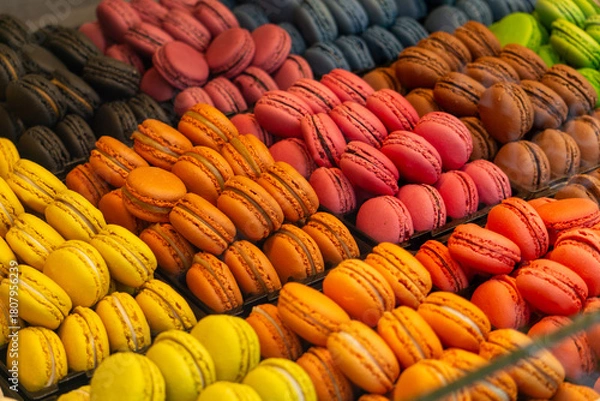 Fototapeta Colorful French Macarons Display in Bakery Shop Window - Vibrant Dessert Pastry Assortment