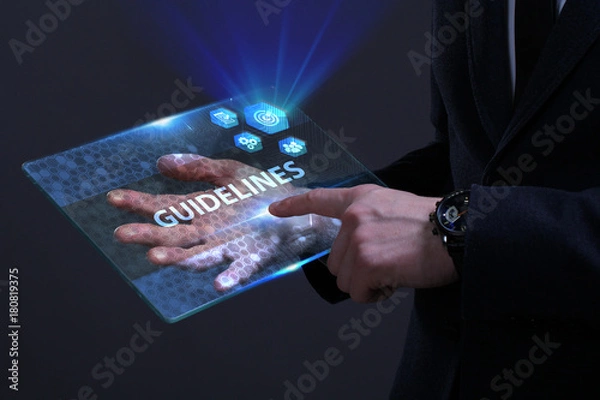 Fototapeta Business, Technology, Internet and network concept. Young businessman working on a virtual screen of the future and sees the inscription: Guidelines