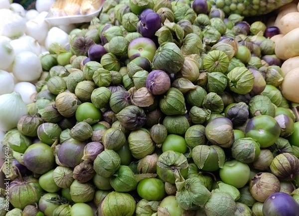 Obraz Tomatillos in market with husks partially open, green tomatillos concept