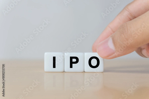 Fototapeta Businessman hand holding IPO (Initial Public Offering) word with dice, shares of a private corporation to the public in a new stock issuance. Stock, Fund, Investors and Investment concept