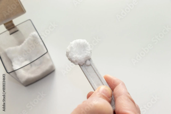 Fototapeta 計量スプーンで砂糖をすくう