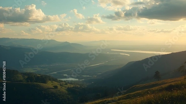 Fototapeta A cinematic photo of a serene and picturesque landscape featuring rolling hills, majestic mountains, lush green forests, and sparkling water bodies beneath a vast open sky