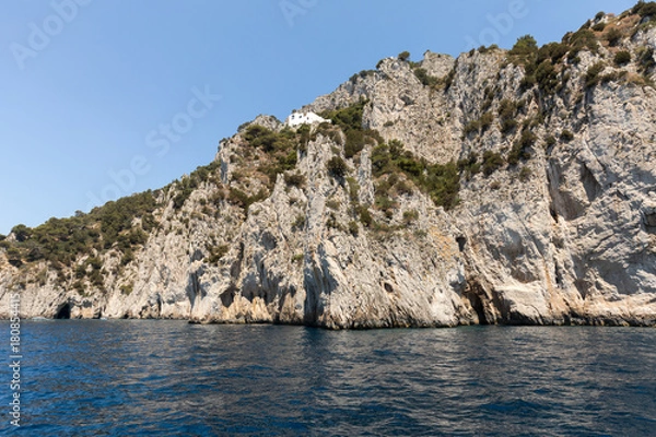 Fototapeta View from the boat on the cliff coast of Capri Island, Italy