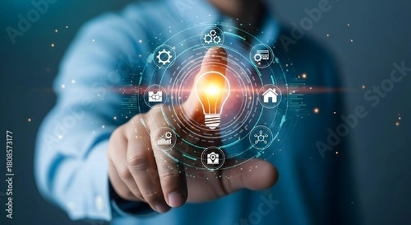 Obraz Businessman touching digital interface with light bulb and technology icons