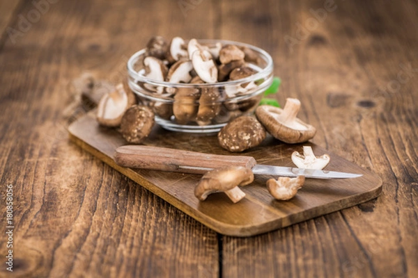 Fototapeta Portion of Raw Shiitake mushrooms on wooden background, selective focus