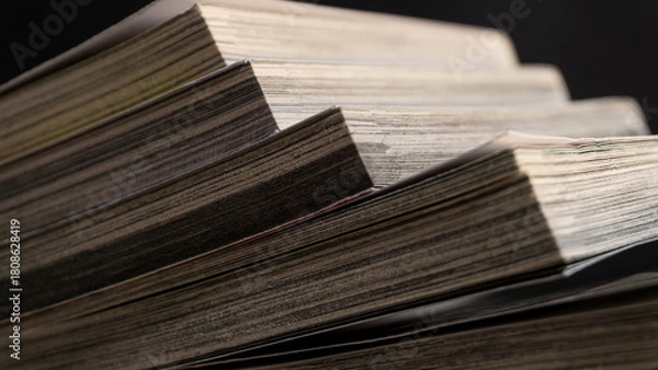 Obraz Sharp close-up of angled book pages in soft focus, revealing intricate texture and natural wear, ideal for backgrounds related to reading, literature, or research.
