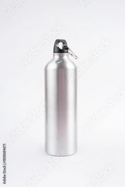 Fototapeta The gray drinking bottle is placed on a clean white background, creating a simple and modern look