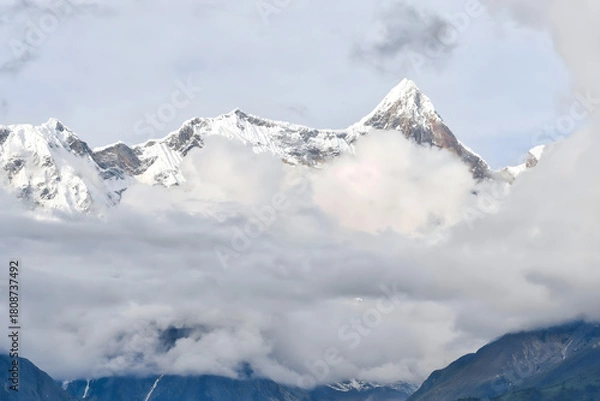 Obraz Alpine Peaks Emerging Through Clouds - Majestic Snowcapped Mountain Landscape