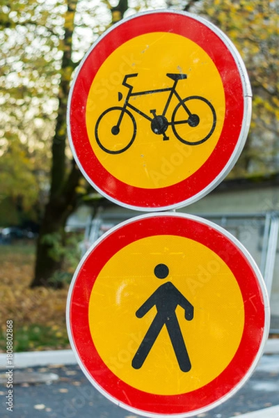Fototapeta traffic signs for bicycle and pedestrian path in autumn setting