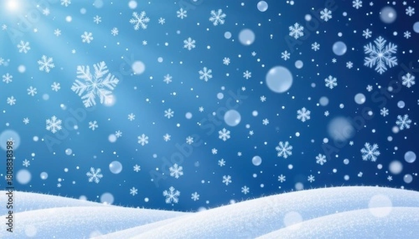 Fototapeta Snowflakes Gently Falling Over a Soft White Blanket of Snow Against a Blue Winter Sky Background