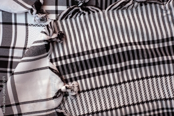 Fototapeta Plaid cloth with black and white stripes and a white fringe