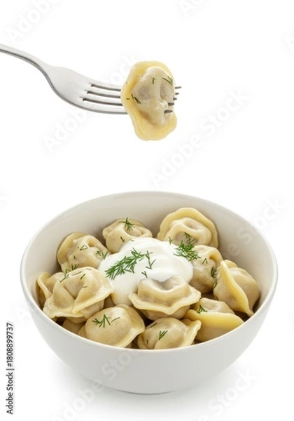 Obraz A fork holding a single pelmeni over a white bowl of Russian dumplings.