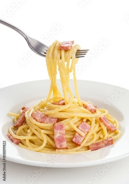 Obraz A fork lifting delicious spaghetti carbonara from a white plate.