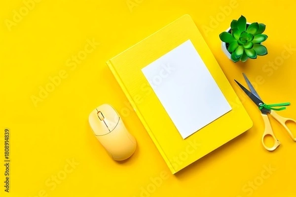 Fototapeta Bright yellow workspace with book mouse scissors and plant