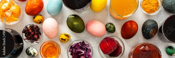 Fototapeta Colorful Easter eggs surround various bowls filled with natural dyes such as beets, turmeric and flower extracts hibiscus, red cabbage and onion peel, showcasing a creative egg decorating process