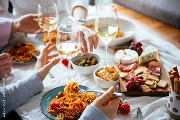 Obraz Friends having a pasta dinner with wine at home.