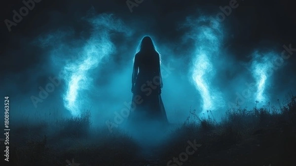 Obraz A mysterious figure stands in a foggy landscape, enveloped in blue light, creating an otherworldly atmosphere