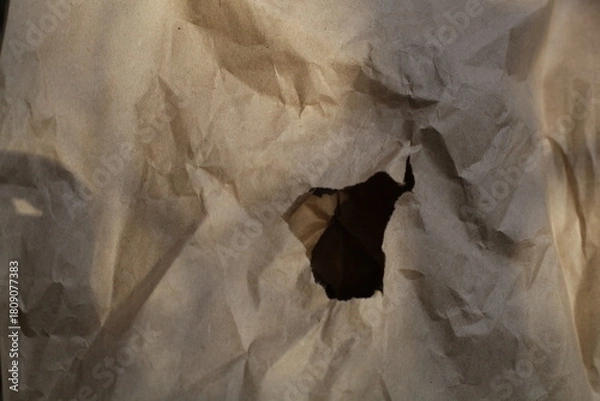 Fototapeta crumpled paper cardboard texture in the center a hole for text copy space,