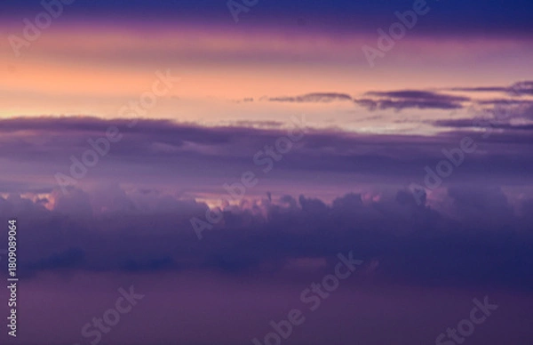 Fototapeta Luminous sky painted by sunset hues, illuminating drifting clouds beautifully