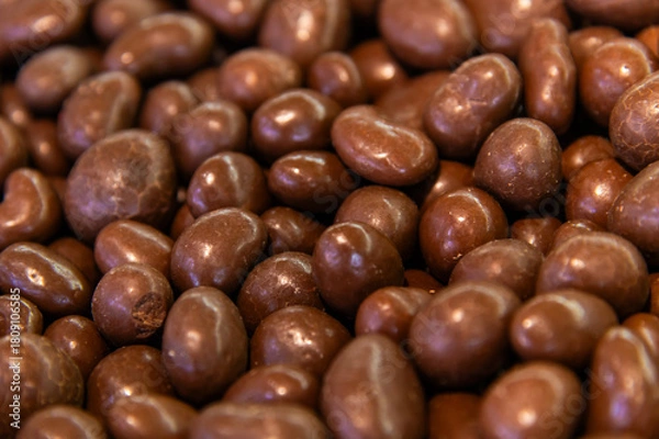 Obraz Close-up of brown dragee, chocolate covered nuts, sweet candy background.