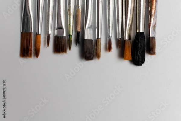 Obraz Close up of a group of artist brushes on a white table. The brushes are of different sizes and materials. Art supplies