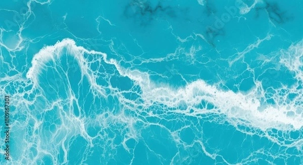 Obraz Aerial view of ocean waves crashing on the shore, creating white foam.