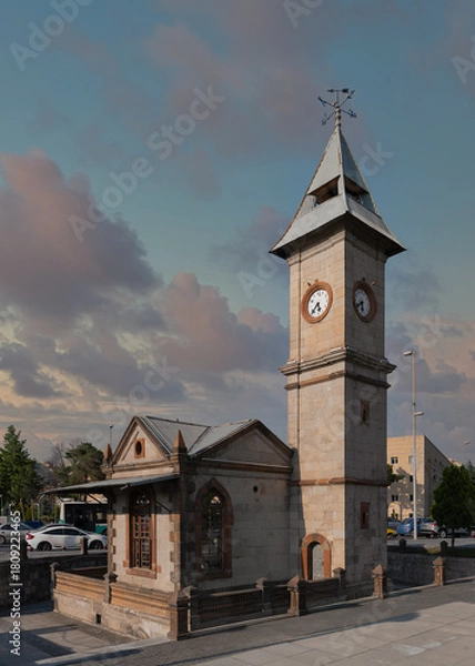 Fototapeta Kayseri Clock Tower, Saat Kulesi, a historic stone landmark with multiple clocks and a weathervane, under a cloudy sky in Kayseri, Turkey.