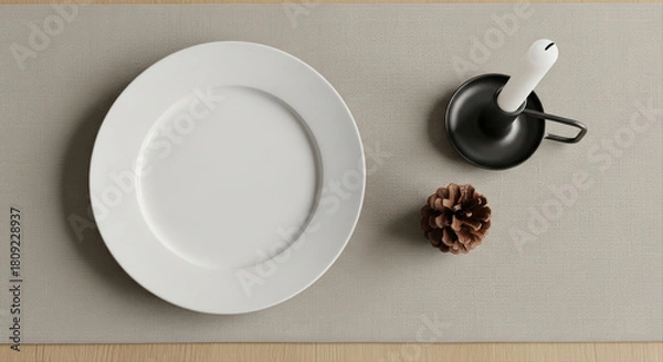 Obraz White ceramic plate on linen runner with minimal styling. Pine cone and simple candle holder beside the place. Nordic style Christmas table setting, minimalist, neutral tones