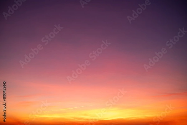 Fototapeta Sunset or sunrise sky with a vibrant gradient of orange, gold, and soft blue. Clear atmosphere with wispy clouds. Peaceful, natural light background. hope, freedom, new day and inspirational Concepts