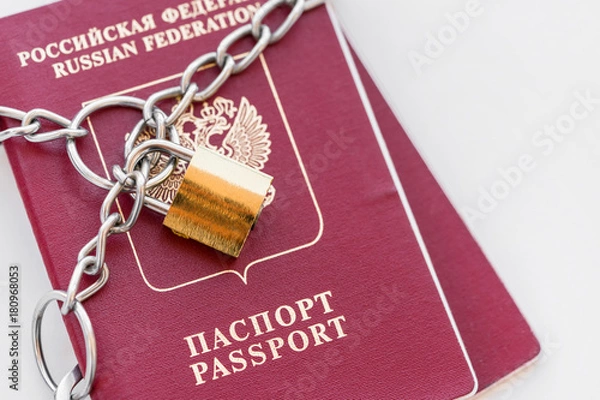 Fototapeta Two Russian Passports covered with a chain with a golden Lock on a white background. Isolated
