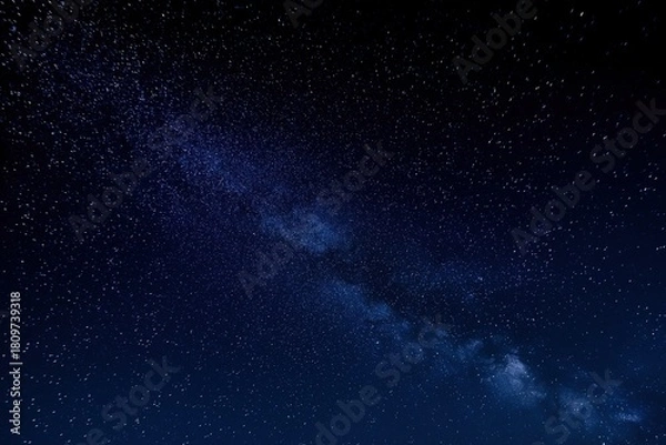 Fototapeta Expansive starry night sky with the Milky Way galaxy, a vast universe filled with scattered stars under a dark blue cosmos, for astronomy and science concepts.