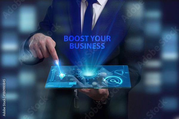 Fototapeta Business, Technology, Internet and network concept. Young businessman working on a virtual screen of the future and sees the inscription: Boost your business