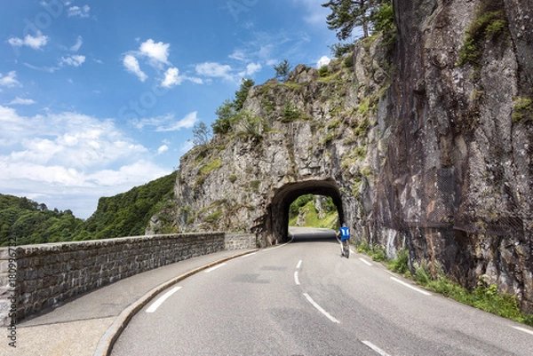 Fototapeta France, Col de la Schlucht: Cyclist in front of road tunnel in rock mountains