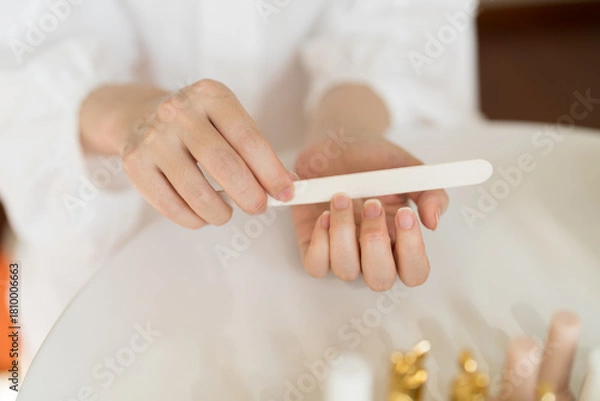 Fototapeta Use a nail file to shape nails