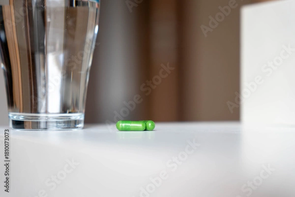 Obraz Green Herbal Capsules with Water on White Surface