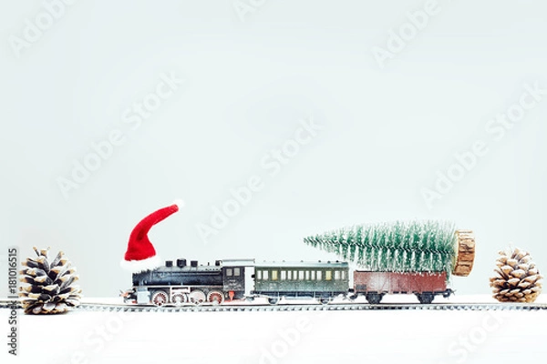 Obraz Xmas toy train in snow with xmas tree on board. Christmas, New Year travel concept.
